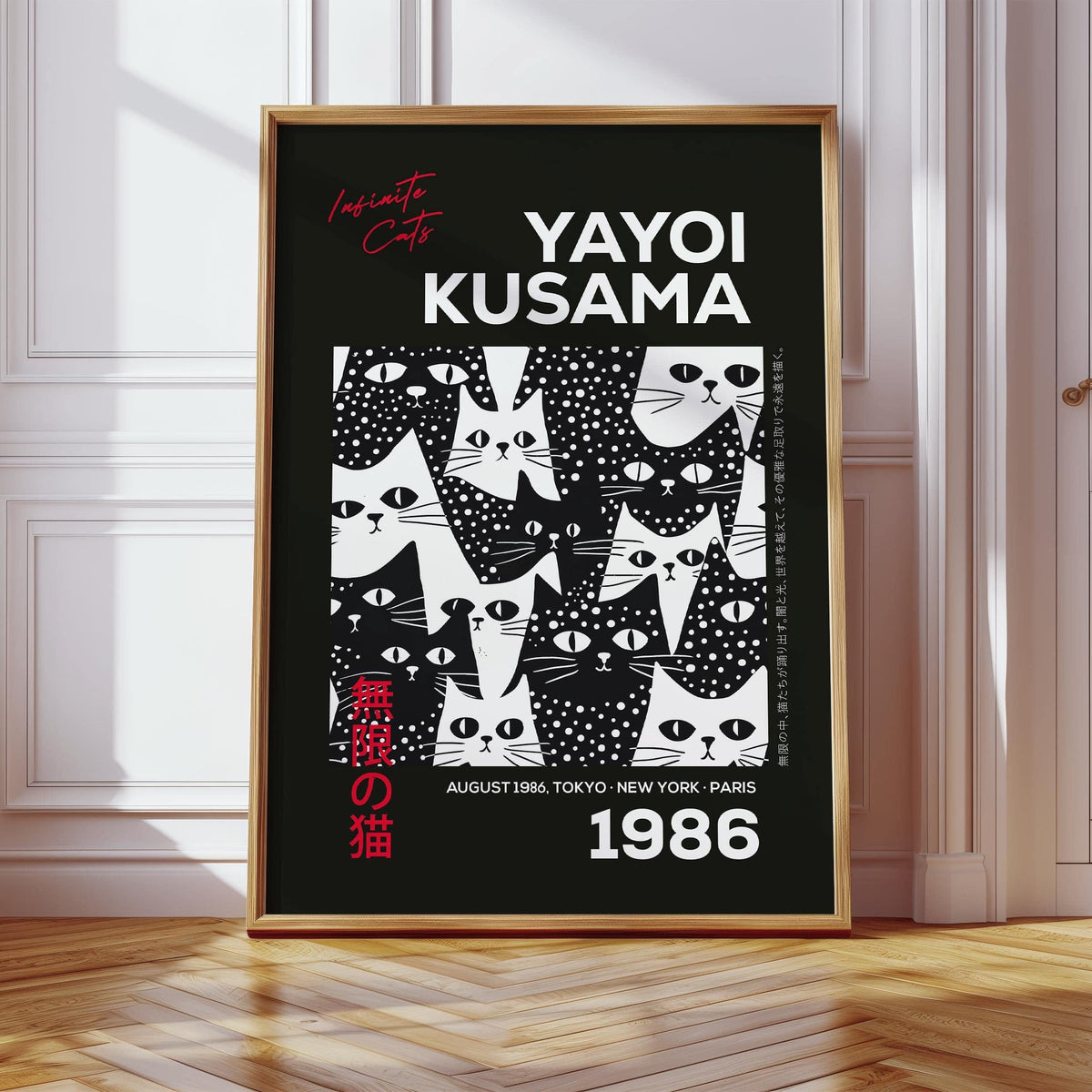 Print leaning on a wooden floor featuring a cats black poster with black and white cat illustrations in sunlight