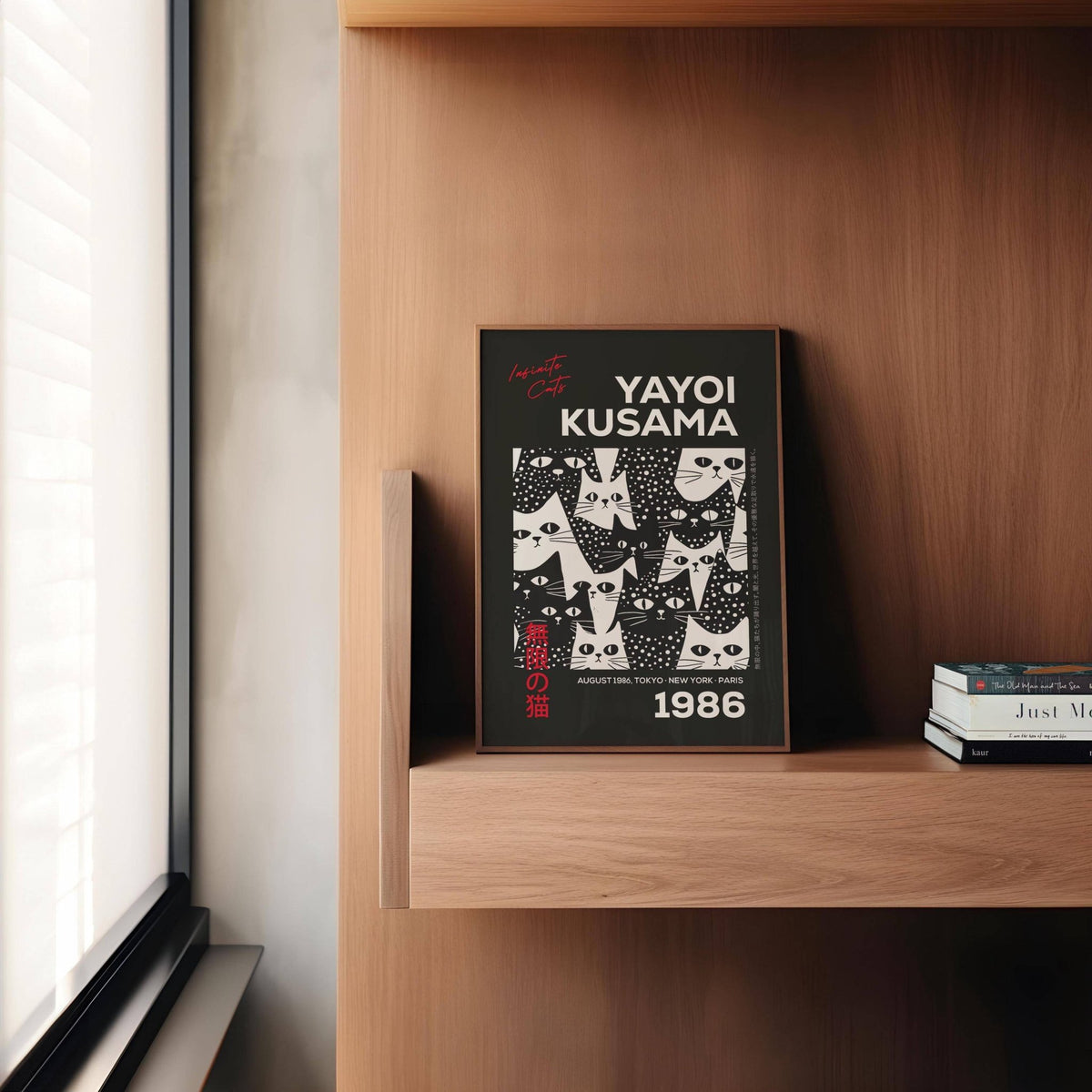 Cats Black Poster leaning on a wooden shelf with books beside it and soft light from a window
