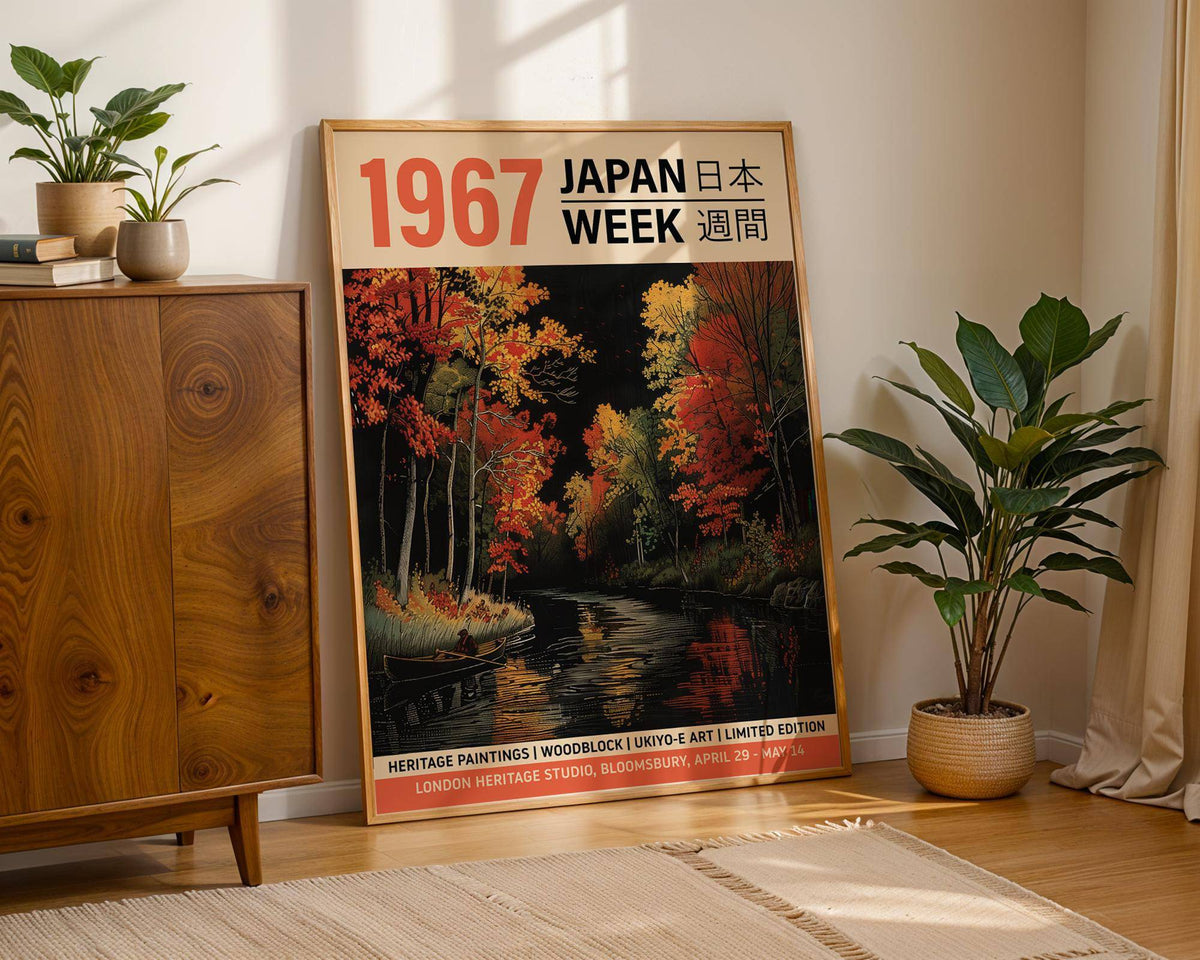 Japanese Woodblock Artwork leaning against wall with autumn river and colourful trees next to a green plant