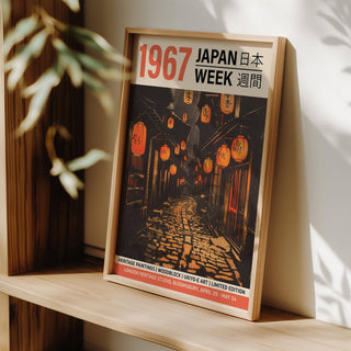 Framed print of Oriental Asian wall art with lantern-lit alley and vintage style leaning on a shelf