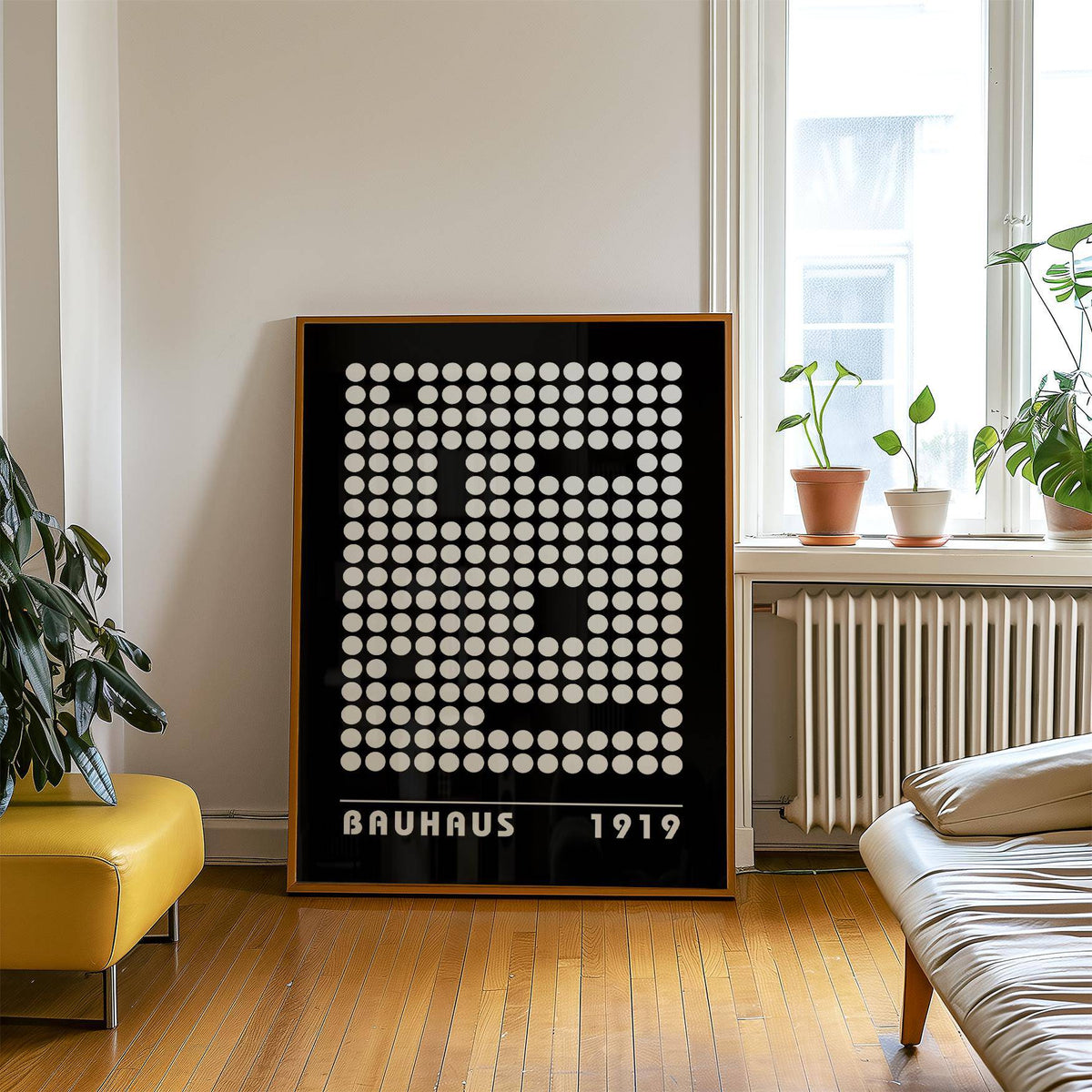 Print leaning on a floor with black and white dot pattern digital wall art and plants on a window sill