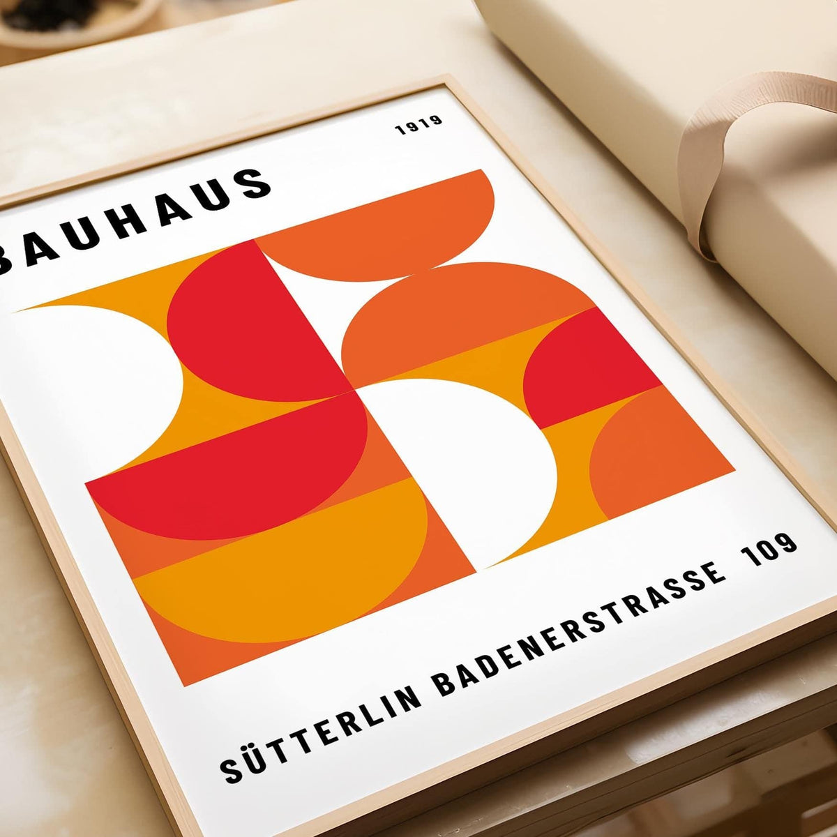 Close-up of Mid Century Wall Art with geometric shapes in red and orange colours on a beige surface