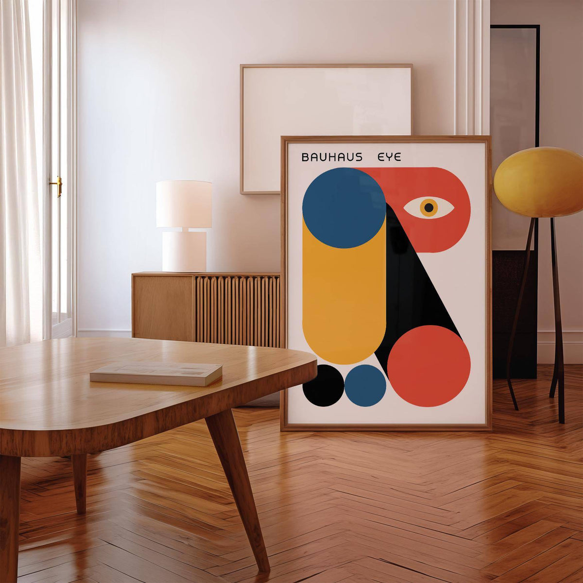 Print leaning on floor of Bauhaus Graphic featuring abstract geometric shapes in blue orange red and black near a retro floor lamp