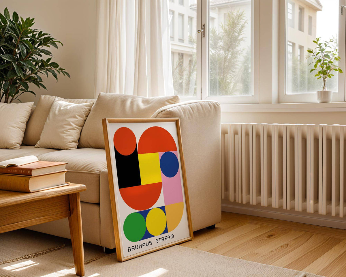 Geometric wall decal with colourful abstract shapes leaning on a living room floor near a sofa and radiator
