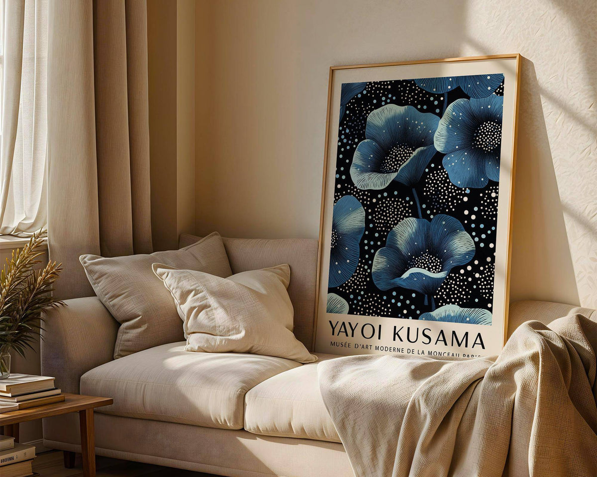 Wall Art Blue Flowers print resting on a sofa with beige cushions and draped fabric