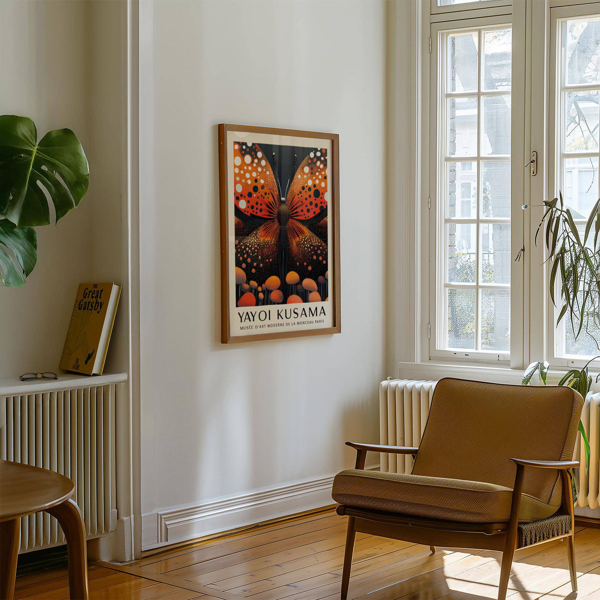 Print on a wall in a living room of abstract butterfly art with orange and black colours above a radiator
