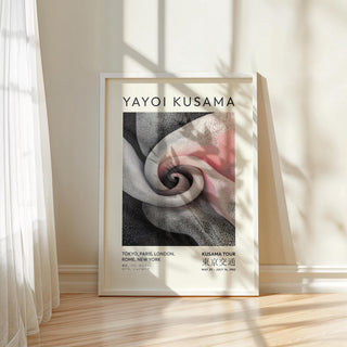 Luxury wall art for living room with spiral dot pattern in black white and pink leaning on floor with soft sunlight