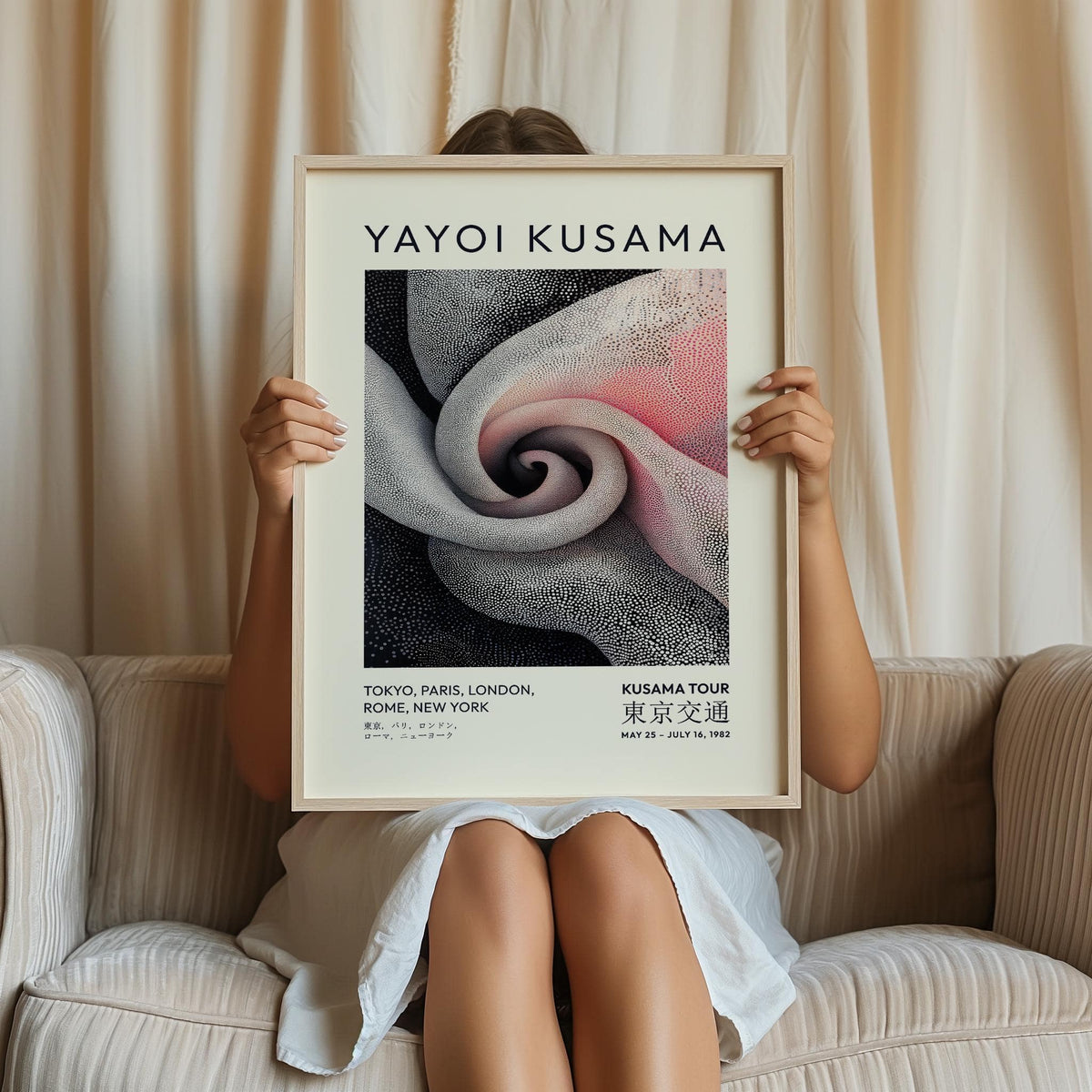 Framed print with Spiral Elegance spiral dot pattern in black and pink held by person sitting on cream sofa