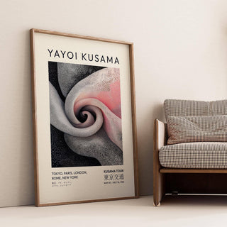 Luxury wall art for living room leaning against a beige wall with a patterned sofa nearby
