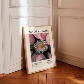Print leaning on floor of abstract flower bloom in pink black and white in a panelled hallway