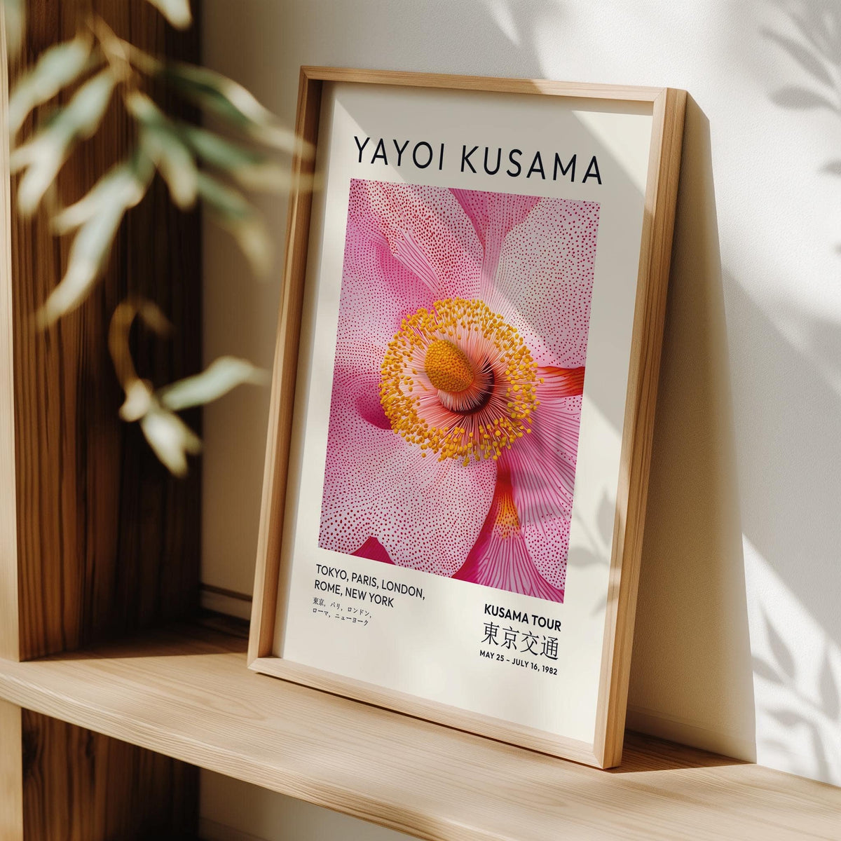 Abstract Pink wall art with detailed pink blossom and yellow centre leaning on a wooden shelf