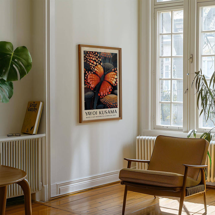 Poster Butterfly framed print with an orange butterfly and dark floral patterns in a room with armchair and plants