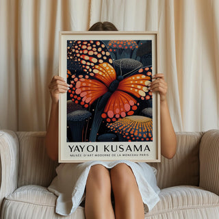 Framed Poster Butterfly with an orange butterfly and dark floral background held by a person on a sofa