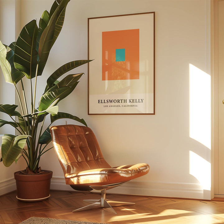 Ellsworth Kelly Artwork framed print with orange and blue squares above a brown leather chair