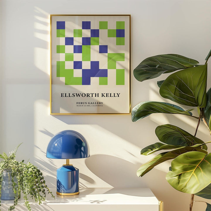 Minimal wall art with green and blue squares framed above a blue table lamp and plants