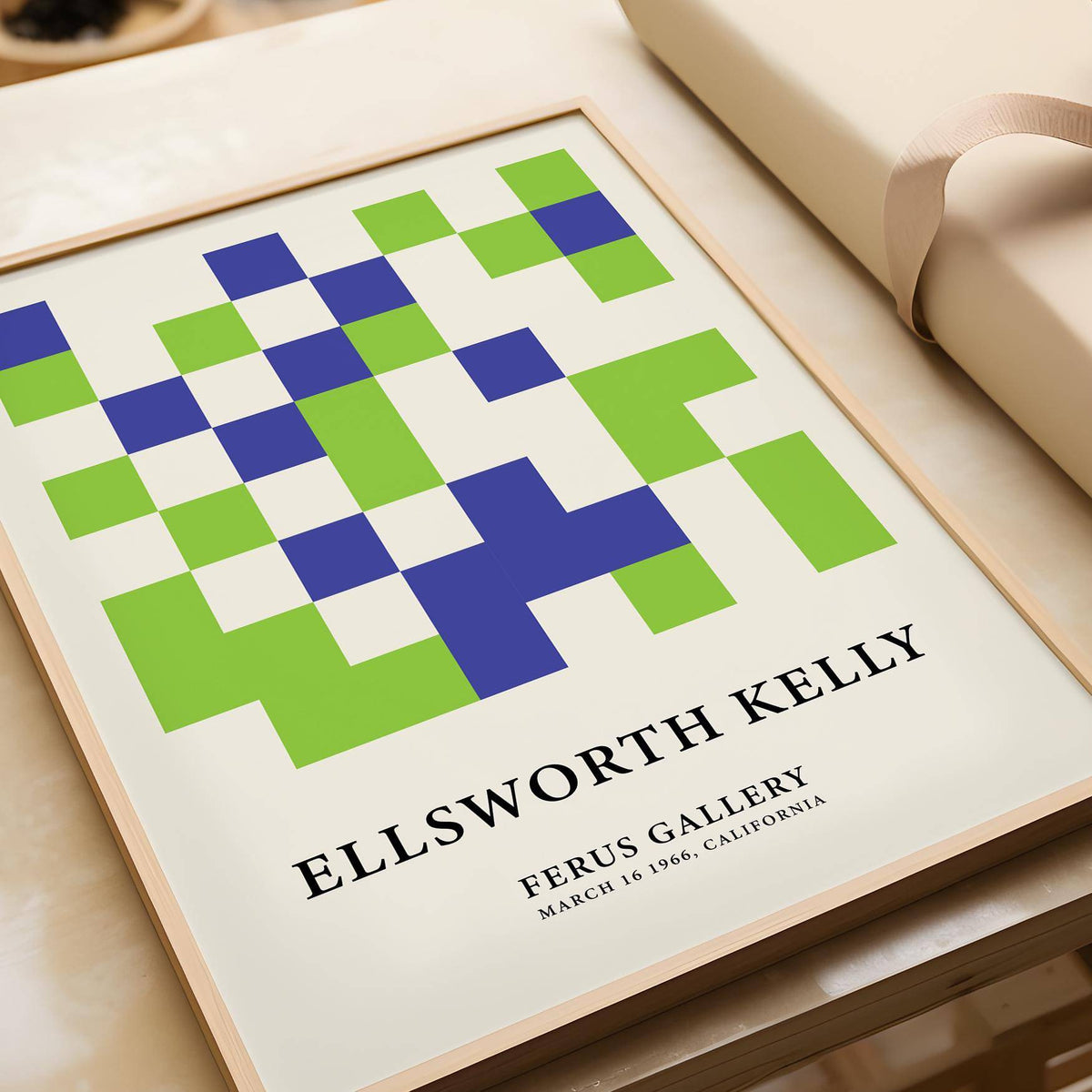 Minimal wall art with green and blue minimalist abstract squares lying on a beige surface by a rolled paper