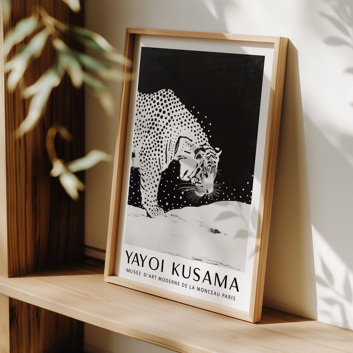Framed White Tiger wall art black and white illustration leaning on a wooden shelf with plant shadow
