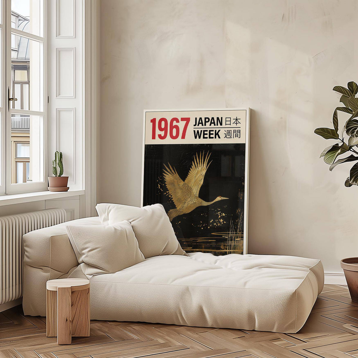 Large Crane Wall Art print leaning beside a cream sofa and small wooden stool with cactus in a bright room