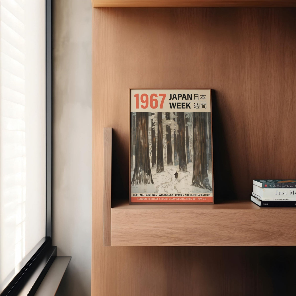 Winter Art Prints leaning on a wooden shelf with a stack of books nearby
