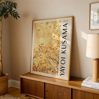 Yellow Nature Art print leaning on a wooden cabinet with a lamp and potted plant