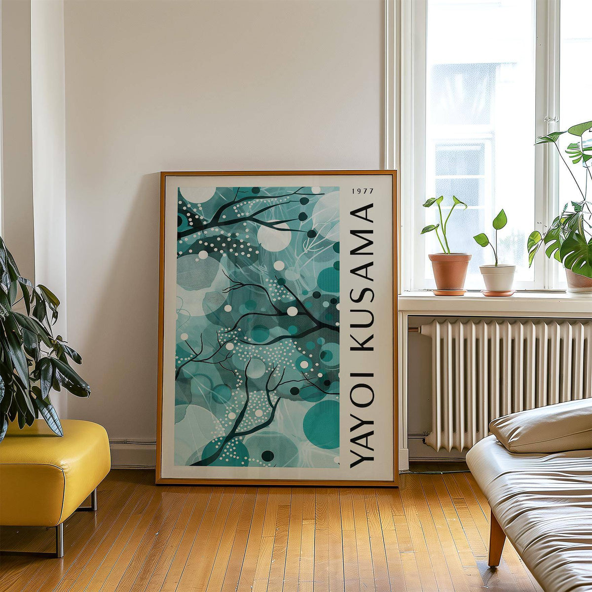 Wall art with teal colors featuring abstract organic shapes leaning on wooden floor near plants