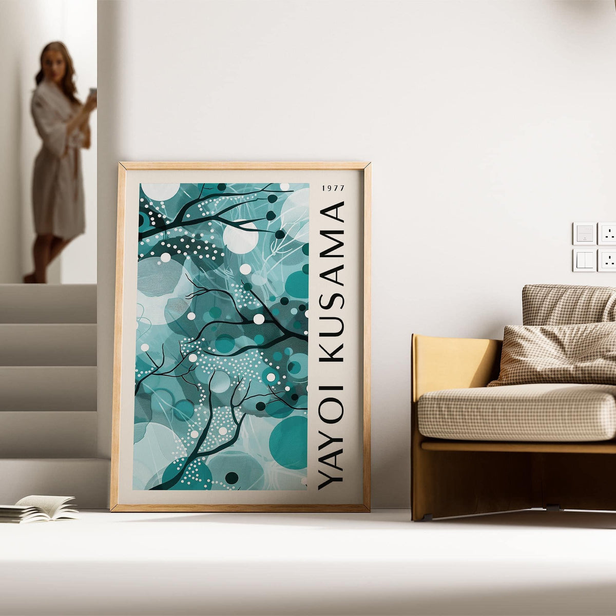 Wall Art with Teal Colours leaning against a wall beside a beige sofa and cushions