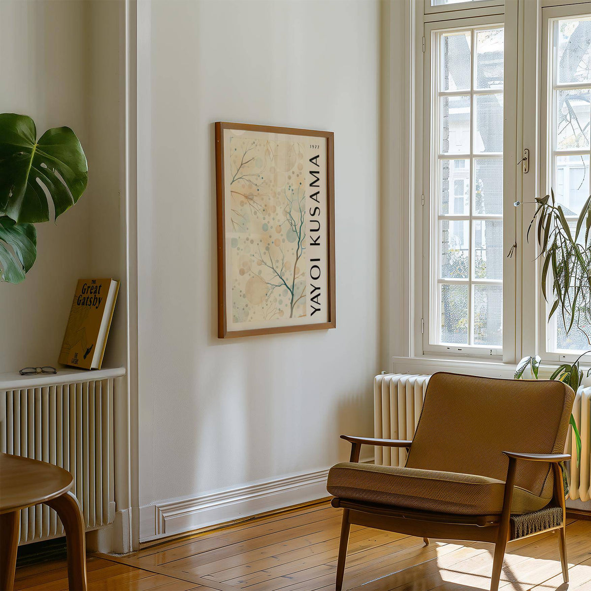 Nature Prints framed print of tree branches with circles in soft beige and blue hanging on a white wall near a brown armchair