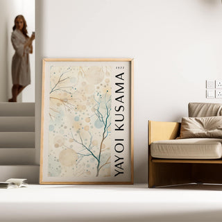 Nature Prints leaning print with abstract tree branches and circles beside a beige sofa