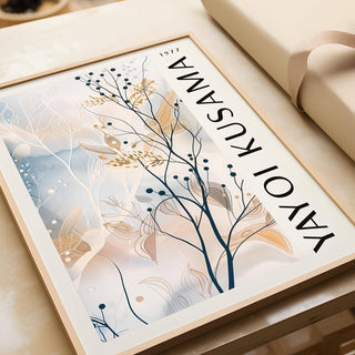 Framed large neutral wall art featuring delicate branches with berries in pastel tones on a table beside wrapping