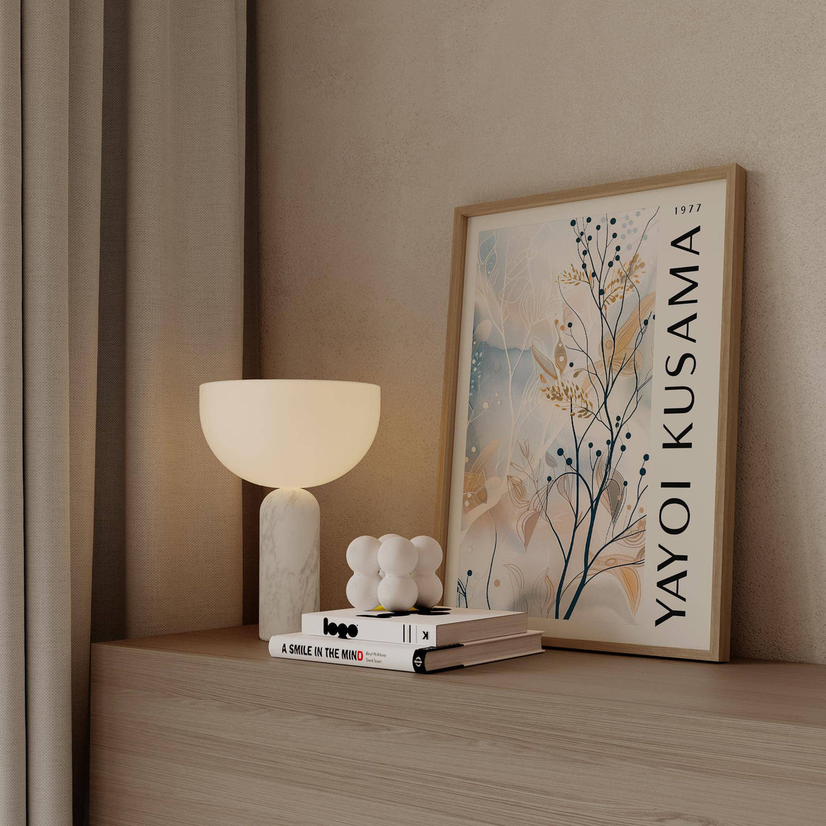 Large Neutral Wall Art framed print leaning on a surface with a white lamp and books nearby