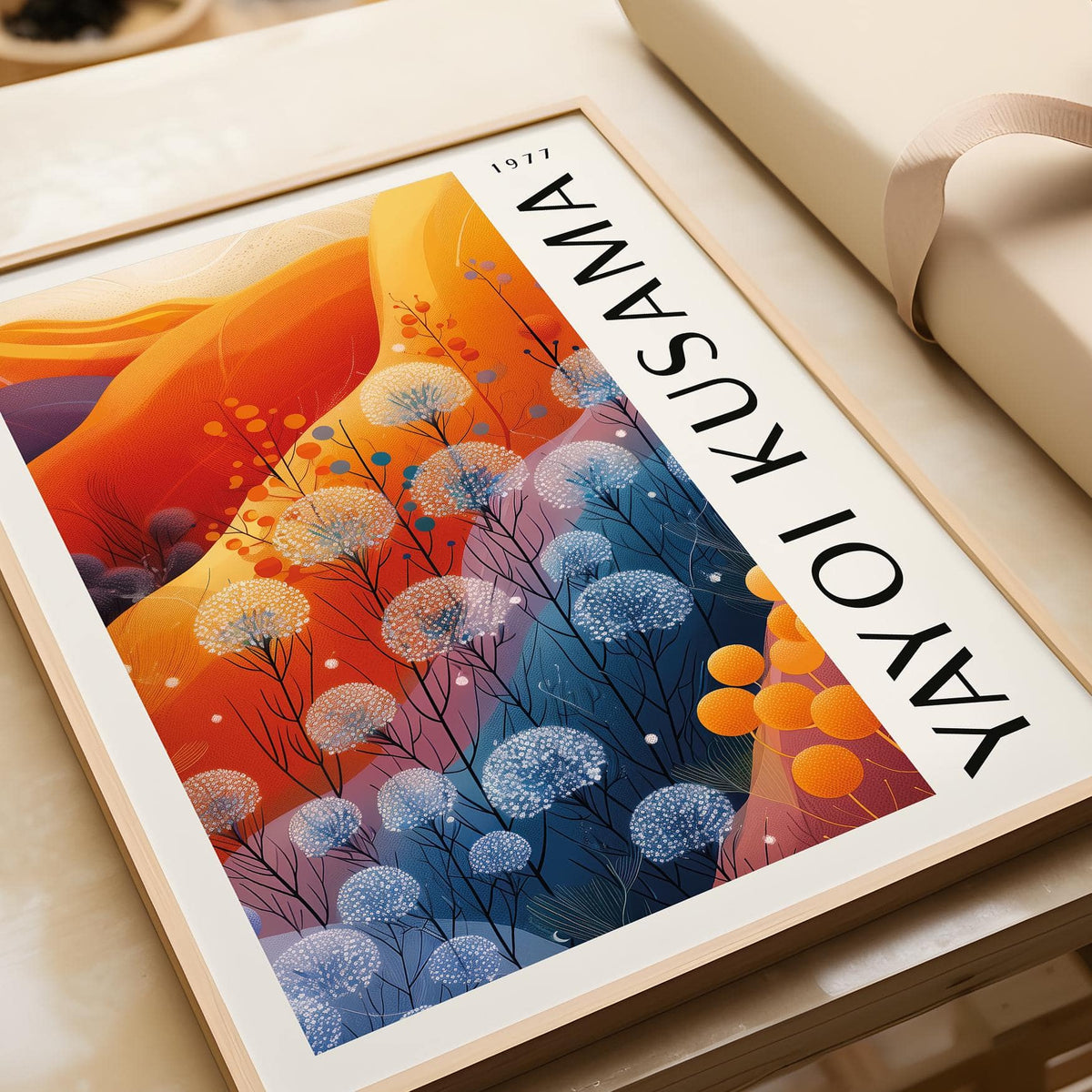 Blue Orange wall decor featuring abstract blue and orange flowers framed on a table with wrapping paper