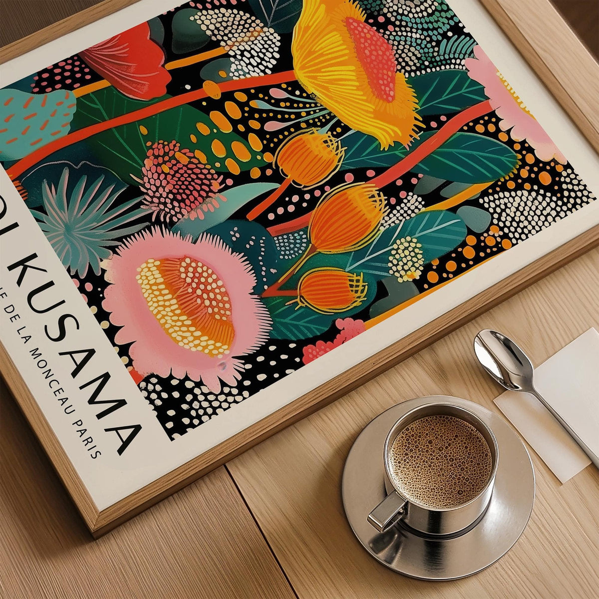 Framed close-up of large wall art modern with colourful abstract floral composition near a coffee cup