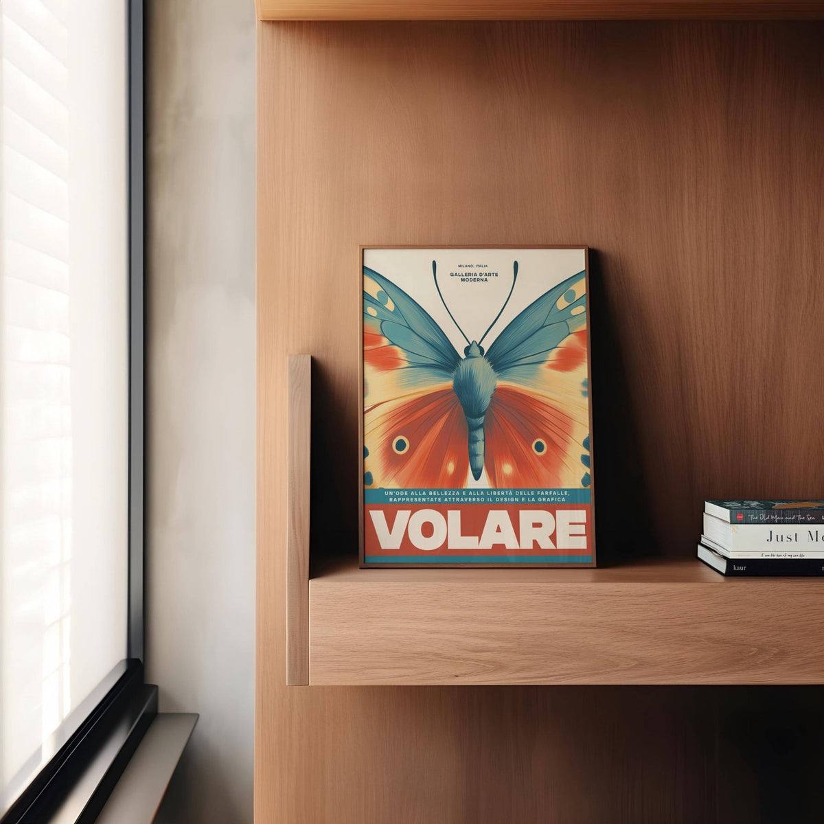 Print leaning on a shelf butterfly wall art with blue and orange vintage wings next to books