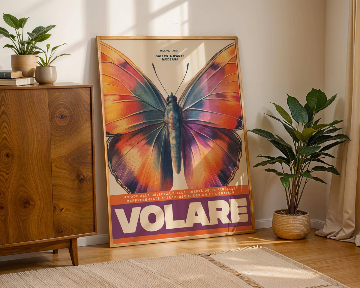 Large Butterfly Print leaning on the floor with vibrant orange and purple butterfly wings and a plant nearby