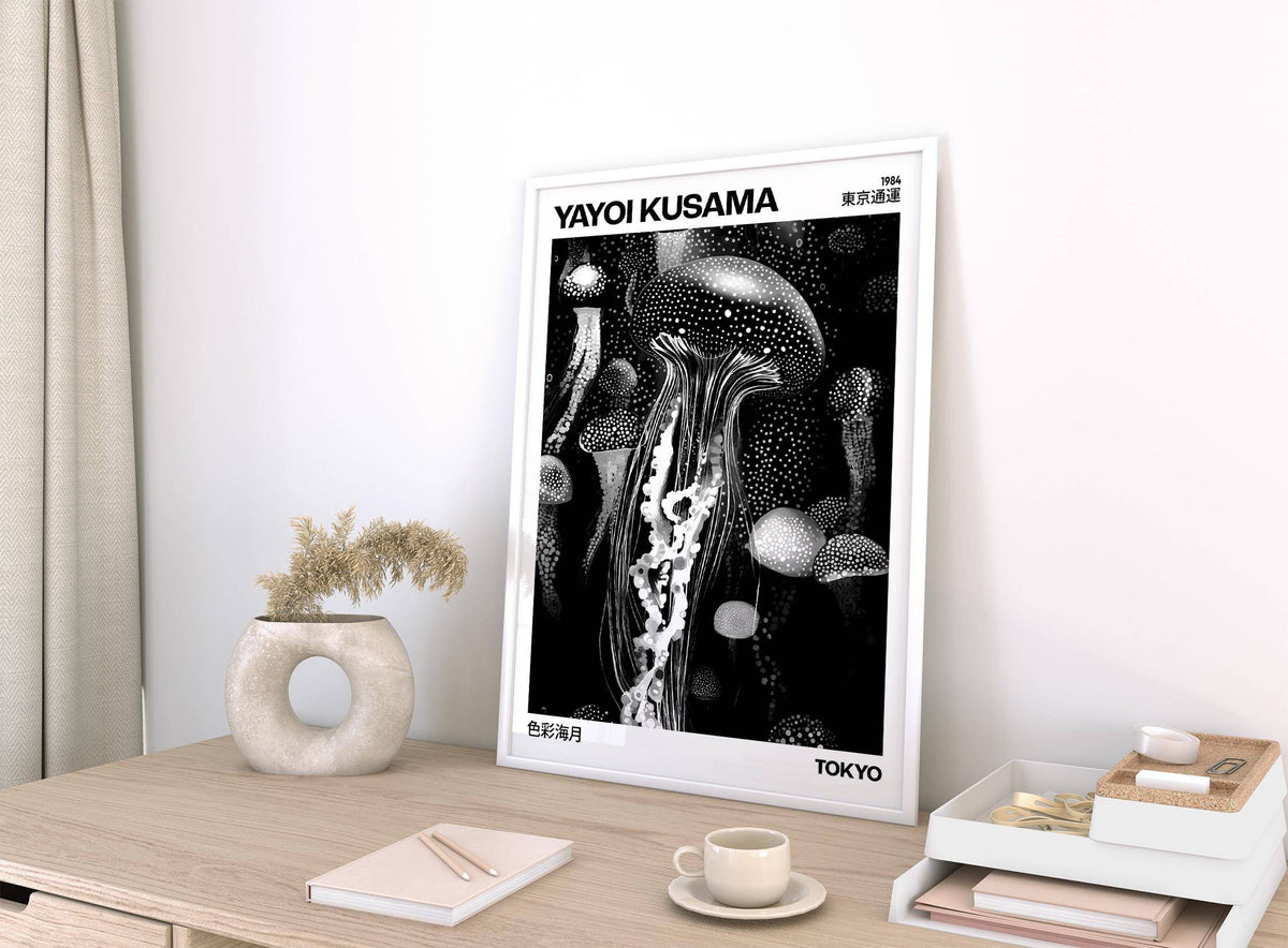 Jellyfish art print leaning on a desk with a circular vase and dried flowers