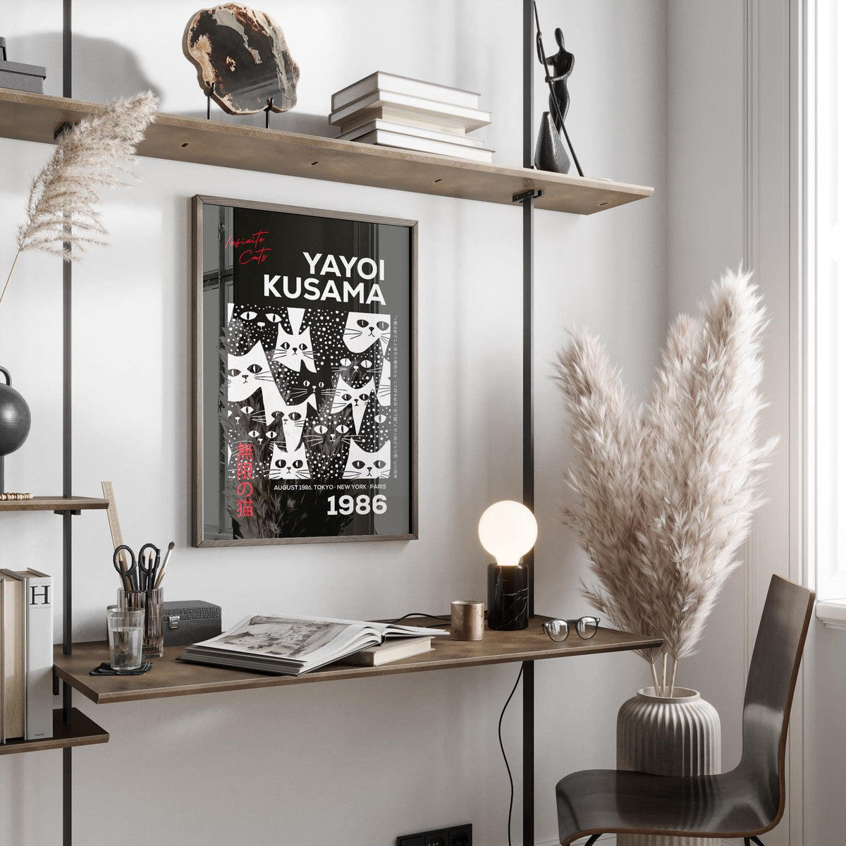 Cats Black Poster framed print with black and white minimalist cats beside pampas grass on a desk