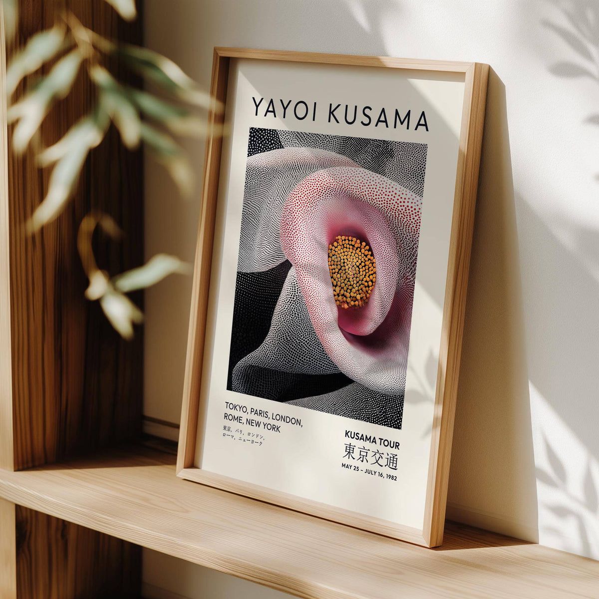 Print leaning on a shelf of a pink calla lily flower with black and white dot pattern background