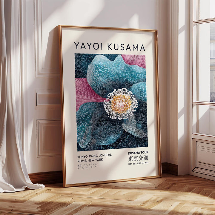 Blue flower artwork leaning on a wooden floor near window with sunlight and a curtain