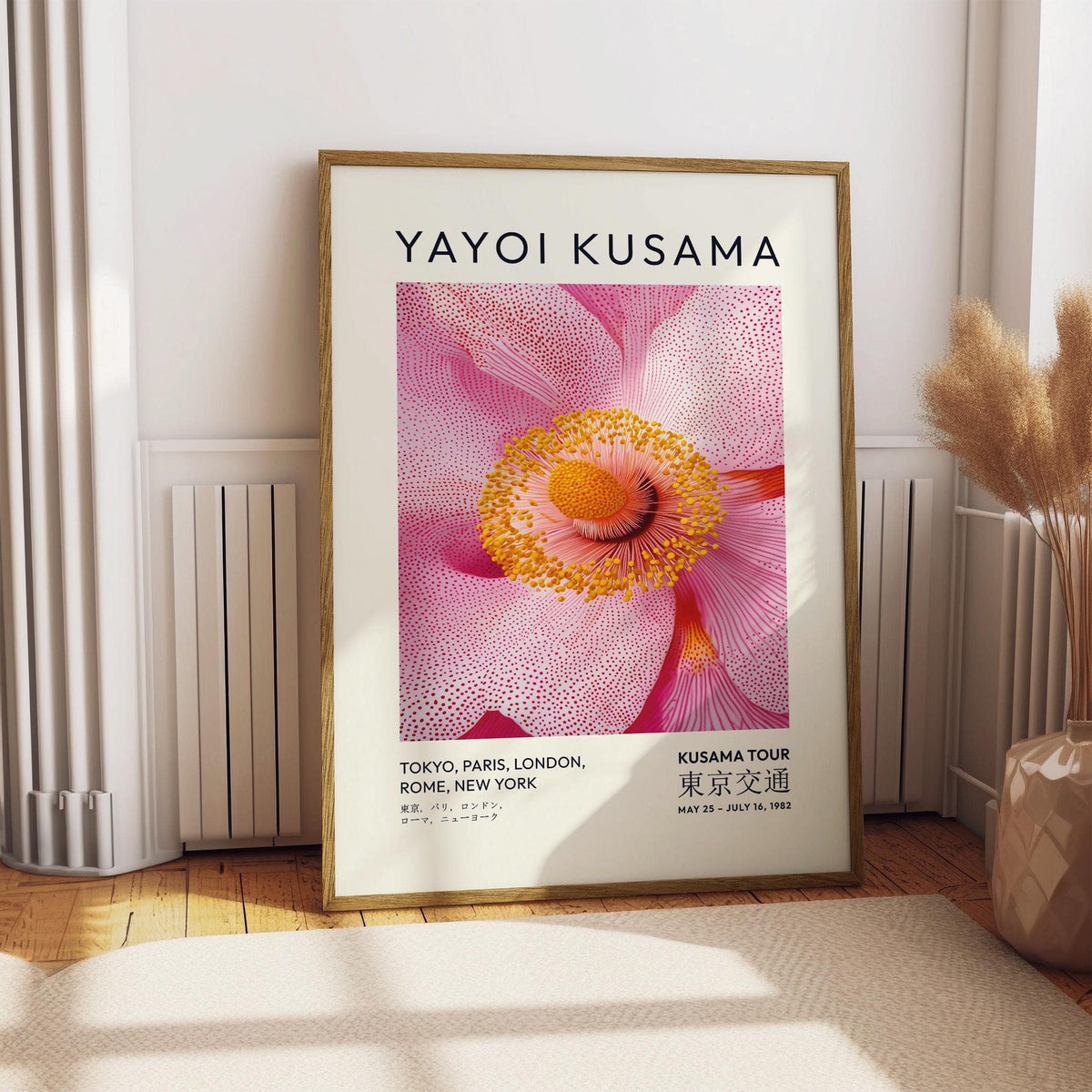 Abstract pink wall art illustration of a blossom flower leaning on a wooden floor near a radiator and pampas grass