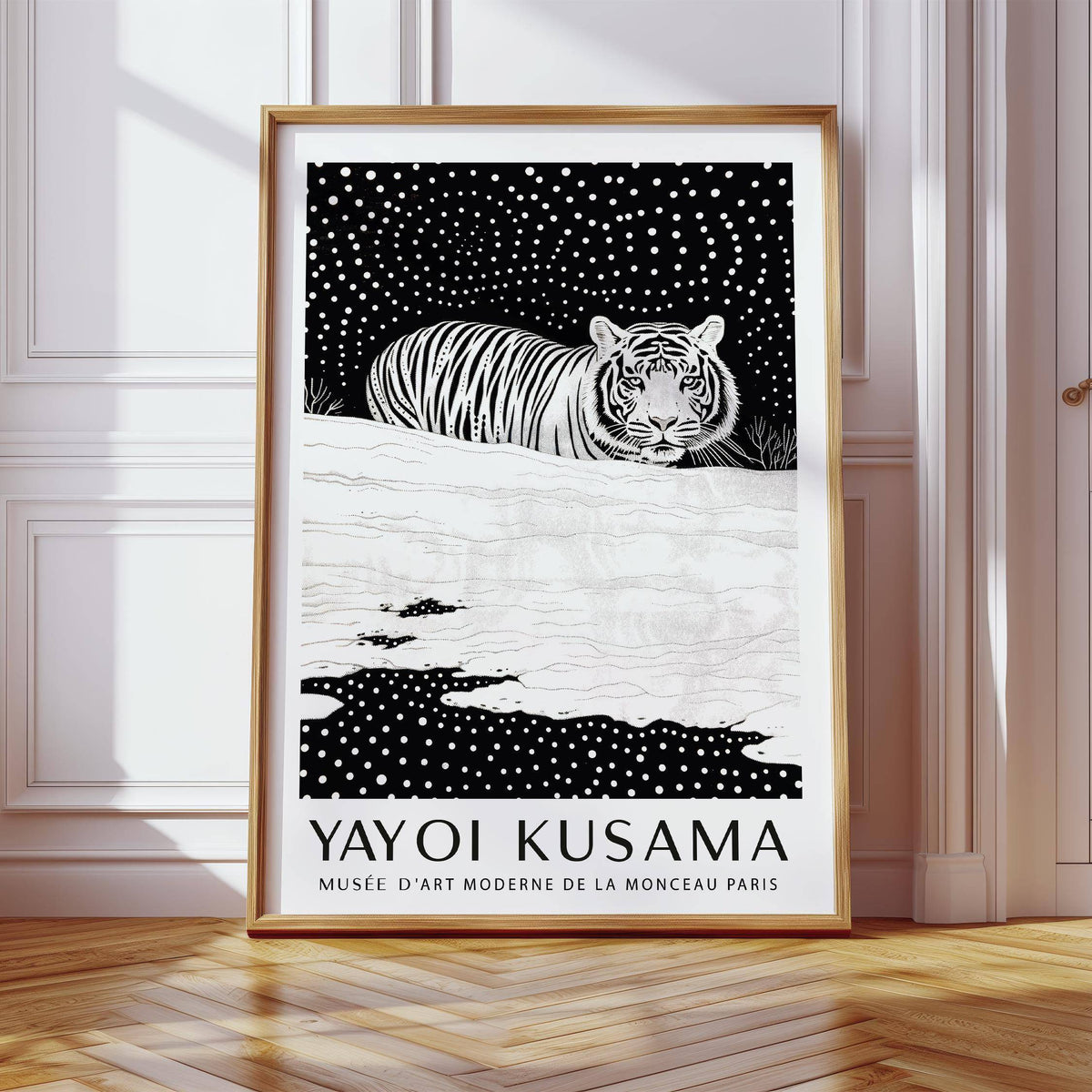 Framed Snow Tiger Print leaning against a white wall on a wooden floor