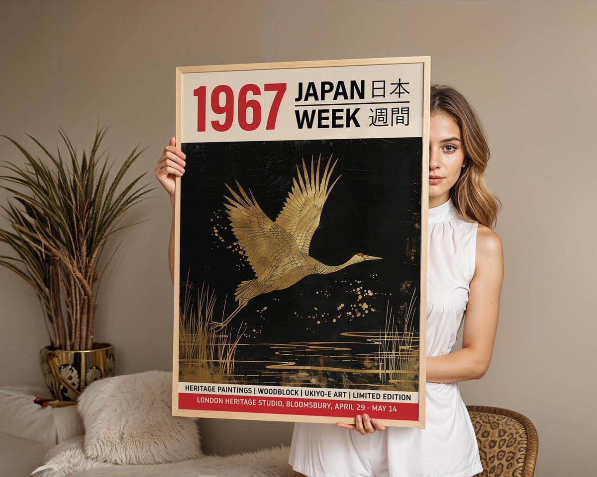 Large Crane wall art held by a woman with gold and black mid-century style crane illustration