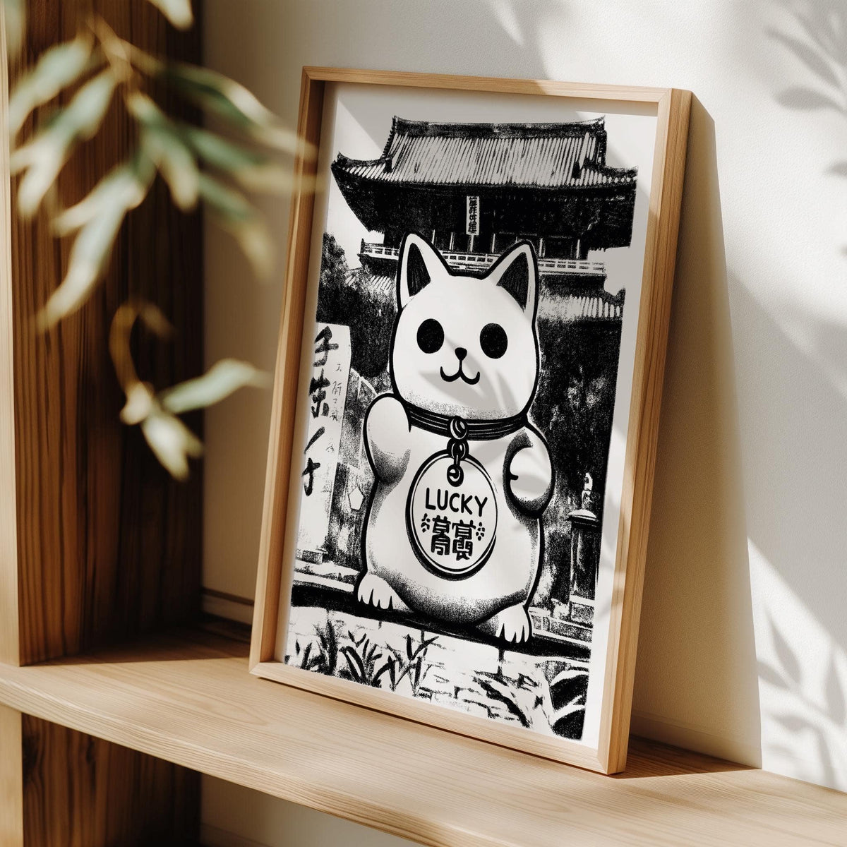 Asian wall decor print of a monochrome lucky cat illustration leaning on a wooden shelf with plant