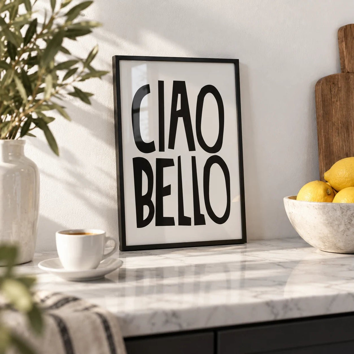Italian Wall Art, a small A4 framed print leaning on a white marble kitchen shelf