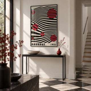 Large Bauhaus Wall Art, framed on the wall of a crisp modern hallway with white walls and a black and white floor
