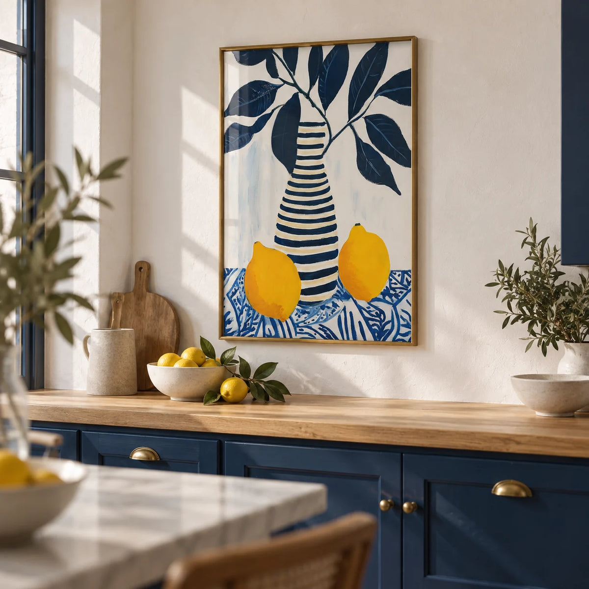 Lemon Art Print, framed on the wall of a Mediterranean-modern kitchen with solid navy cabinets and white limewashed walls