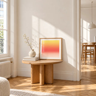 Lemon Sunset Print, a small square framed print leaning on a small solid oak side table
