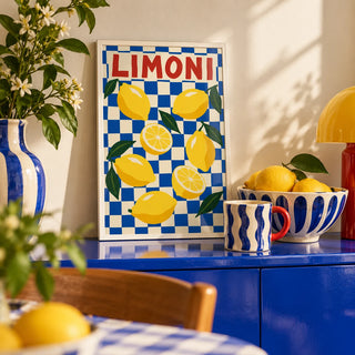 Limoni Checkerboard Print, a small A4 framed print leaning on a colourful lacquered shelf in a living room