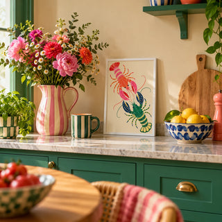 Lobster Wall Art, a small A4 framed print leaning on a kitchen worktop