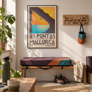 Mallorca Climbing Poster, framed on the wall of a home training room with a white wall and a small wooden hangboard