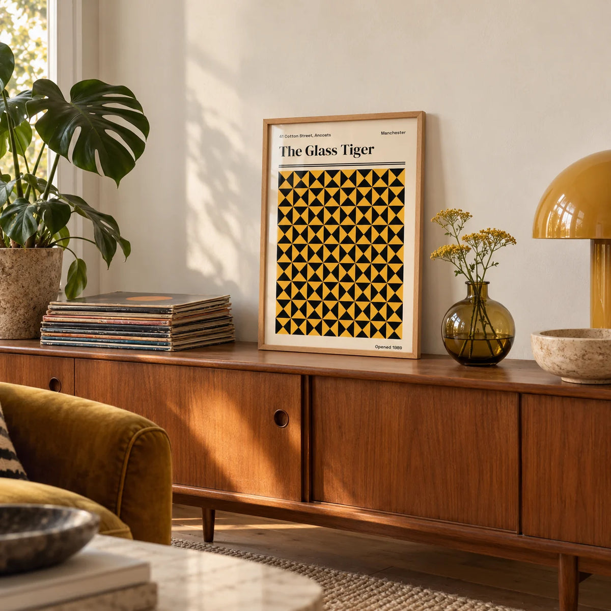 Manchester Art Print, a small A4 framed print leaning on a teak sideboard in a living room